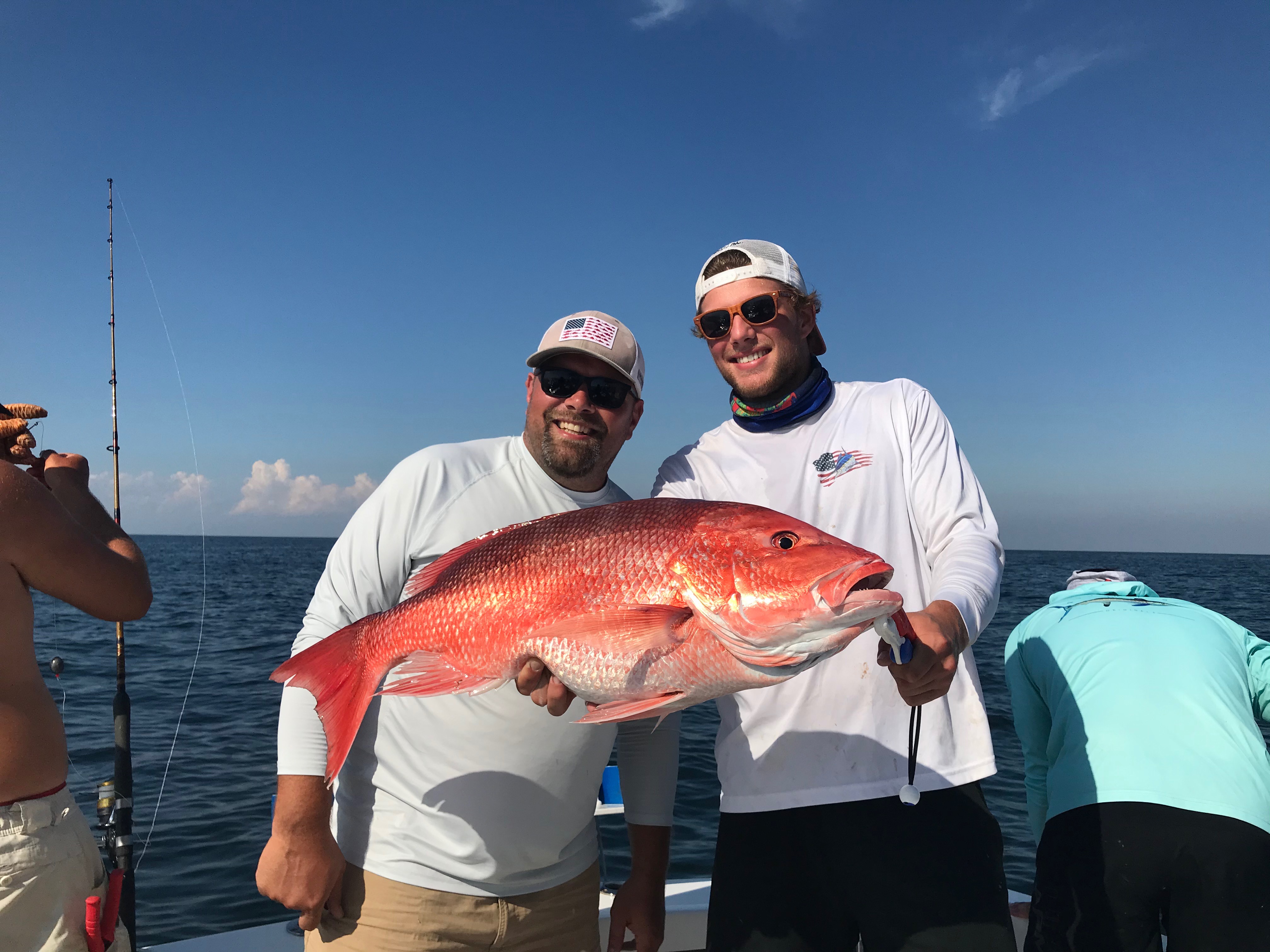 Men holding up a big red snapper
